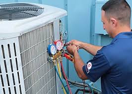 Technician checking refrigerant pressure gauges on an outdoor HVAC unit